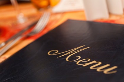 Menu & Cutlery on A Restaurant Table